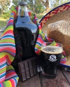 growler of Pancho beer with chocolate bar and sombrero