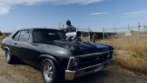 film still of black car