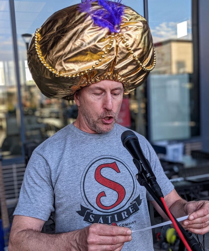 satire brewing man at microphone